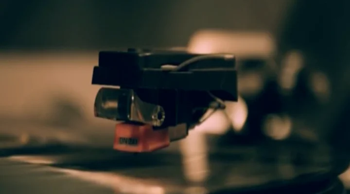 Turntable stylus and cartridge on a vinyl record